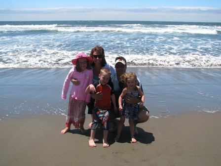 Photo of Chris with his family at the beach